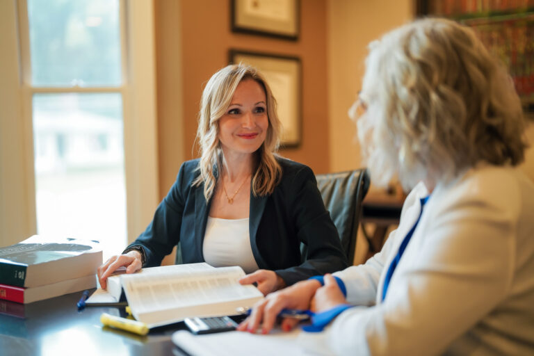 Photo of Christin Gonzalez facing the camera and speaking with Shannon Novey for Novey+Gonzalez Family Law.